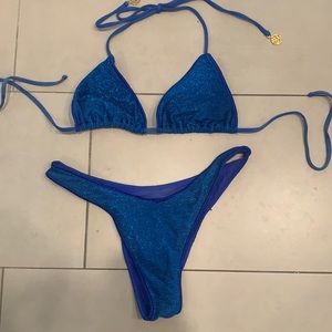 Luli Fama blue sparkle bikini. Triangle top and high leg Brazilian bottom.